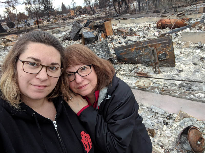 Melissa Geissinger (left) and her mother, Nancy Crain, stand in front of the charred remains of Geissenger's Santa Rosa, California neighborhood. (Photo courtesy of Melissa Geissinger)
