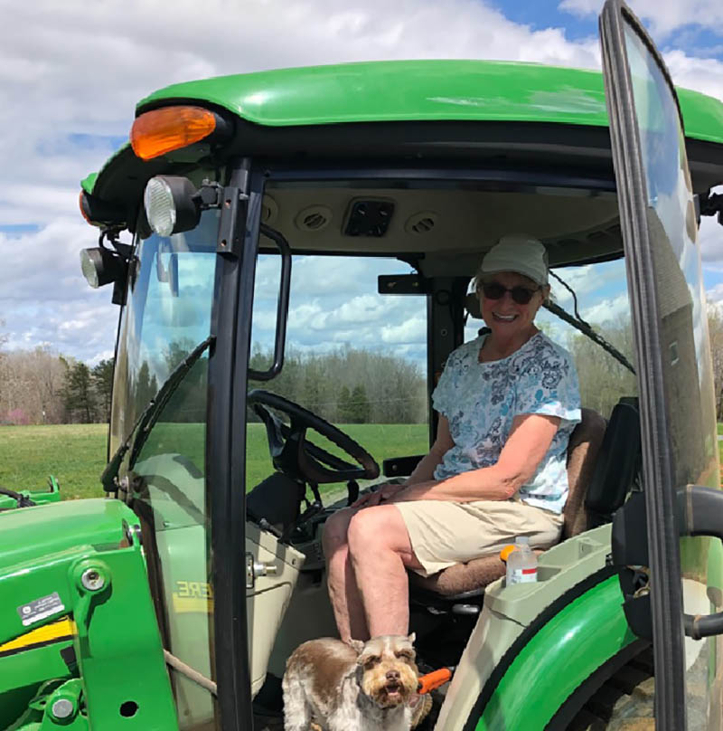 Pamela Anderson Bowen on her tractor with her rescue schnauzer, Rowdy. (Photo courtesy of Pamela Anderson Bowen)