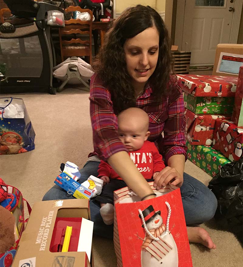 Ashley Hammontree opens a Christmas gift with her son, Elijah, a week after her stroke. (Photo courtesy of Ashley Hammontree)