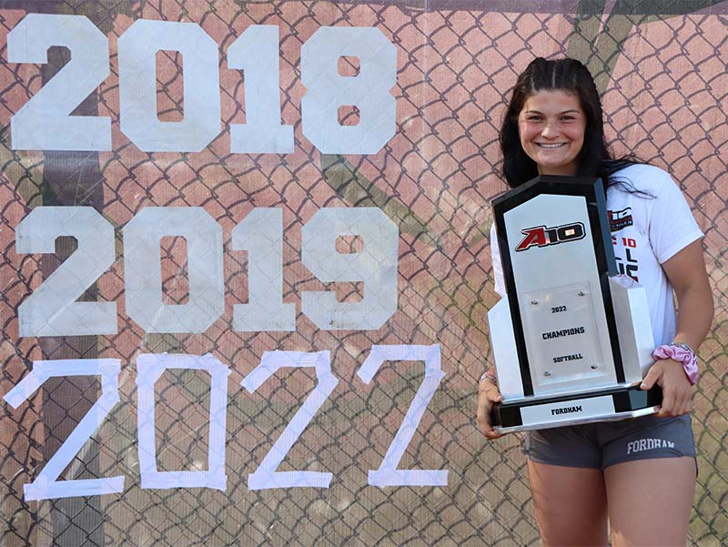 Cardiac arrest survivor and Fordham University softball shortstop Sarah Taffet with her team's championship trophy. (Photo courtesy of Makenzie McGrath)