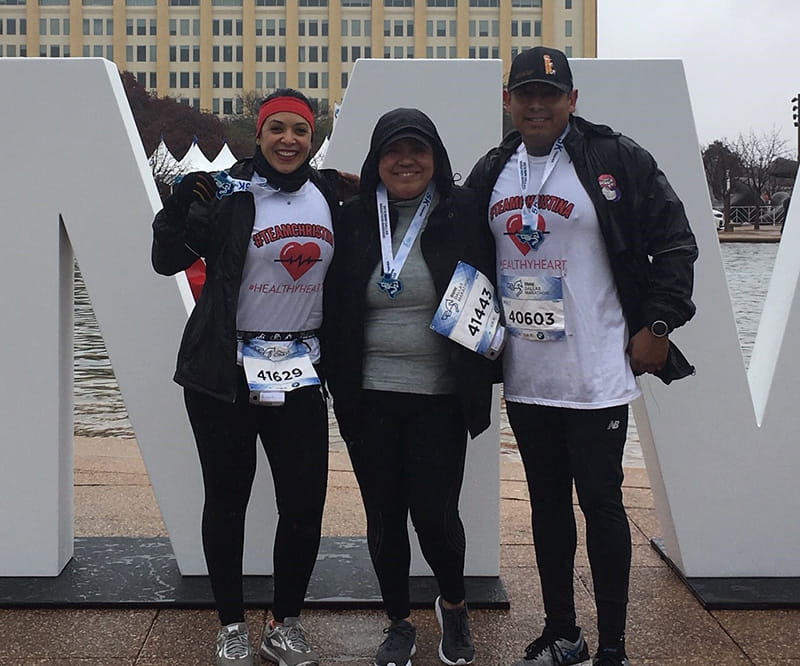 Christina proudly wears the medal she earned at her first 5K, crossing the finish line with friends Juanita and Rey. From left to right: Juanita Cano, Christina Herrera, and Rey Alvarez. (Photo courtesy of Juanita Cano)