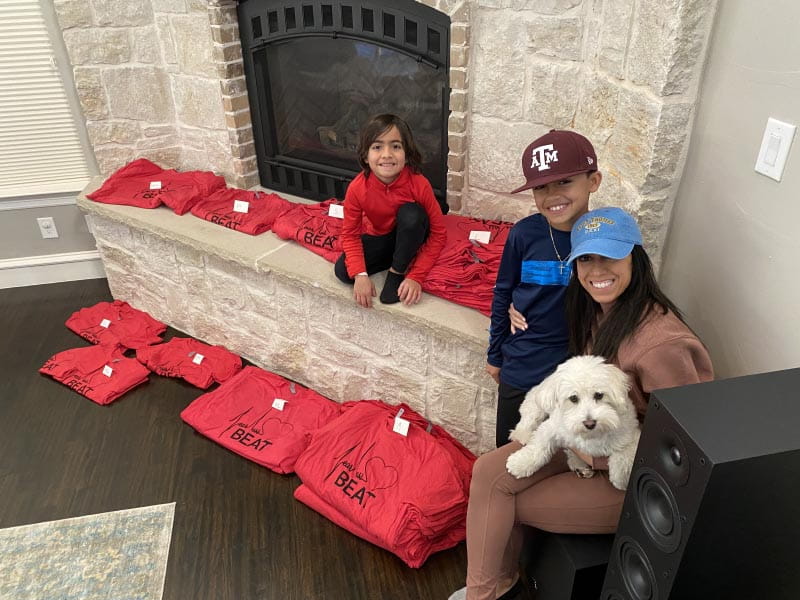 Sheena Fannin (far right) with her sons, Milen (left) and Jay, with t-shirts Sheena sold to raise funds for the AHA. (Photo courtesy of Sheena Fannin)