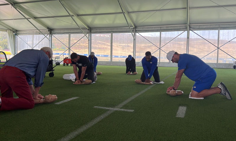 Los Angeles Rams defensive coaches participate in a CPR training course at the team's headquarters – 12 days before Wyatt nearly drowned. (American Heart Association)