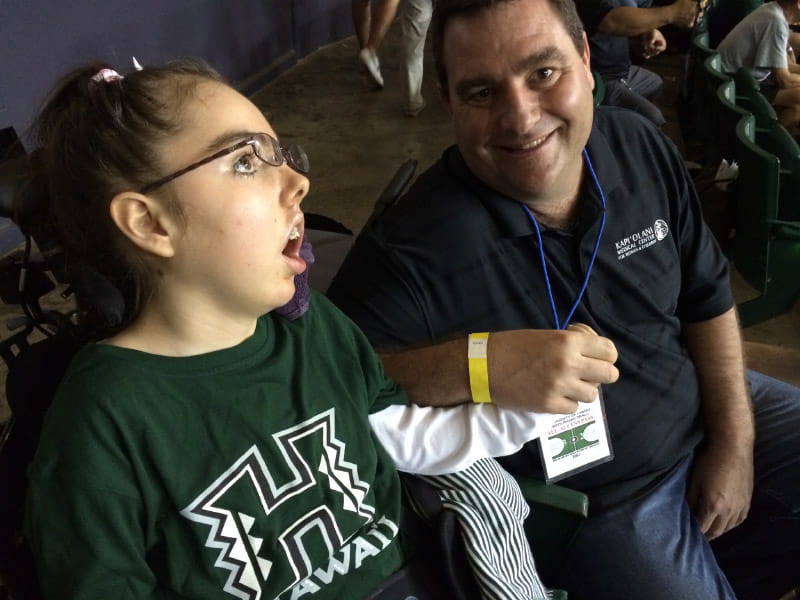 Abbie loved watching the University of Hawaii women's volleyball team. Her dad, Ray, joined her the first time she saw them play in person. (Photo courtesy of the Vara family)