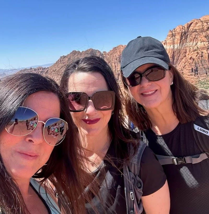 Dr. Julianne Holt-Lunstad (middle) with her sisters Rebekah (left) and Katherine during a hike in southern Utah as part of their annual family trip with all her siblings, nieces and nephews. (Photo courtesy of Dr. Julianne Holt-Lunstad)