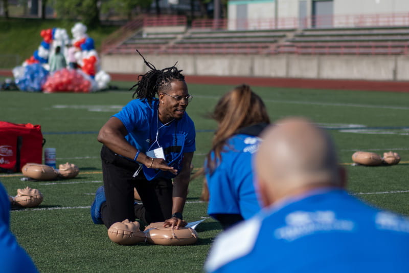 Alik Matthews demonstrates hands-only CPR during a public training event hosted by the American Heart Association and the Buffalo Bills in Buffalo, New York, last June. (American Heart Association)